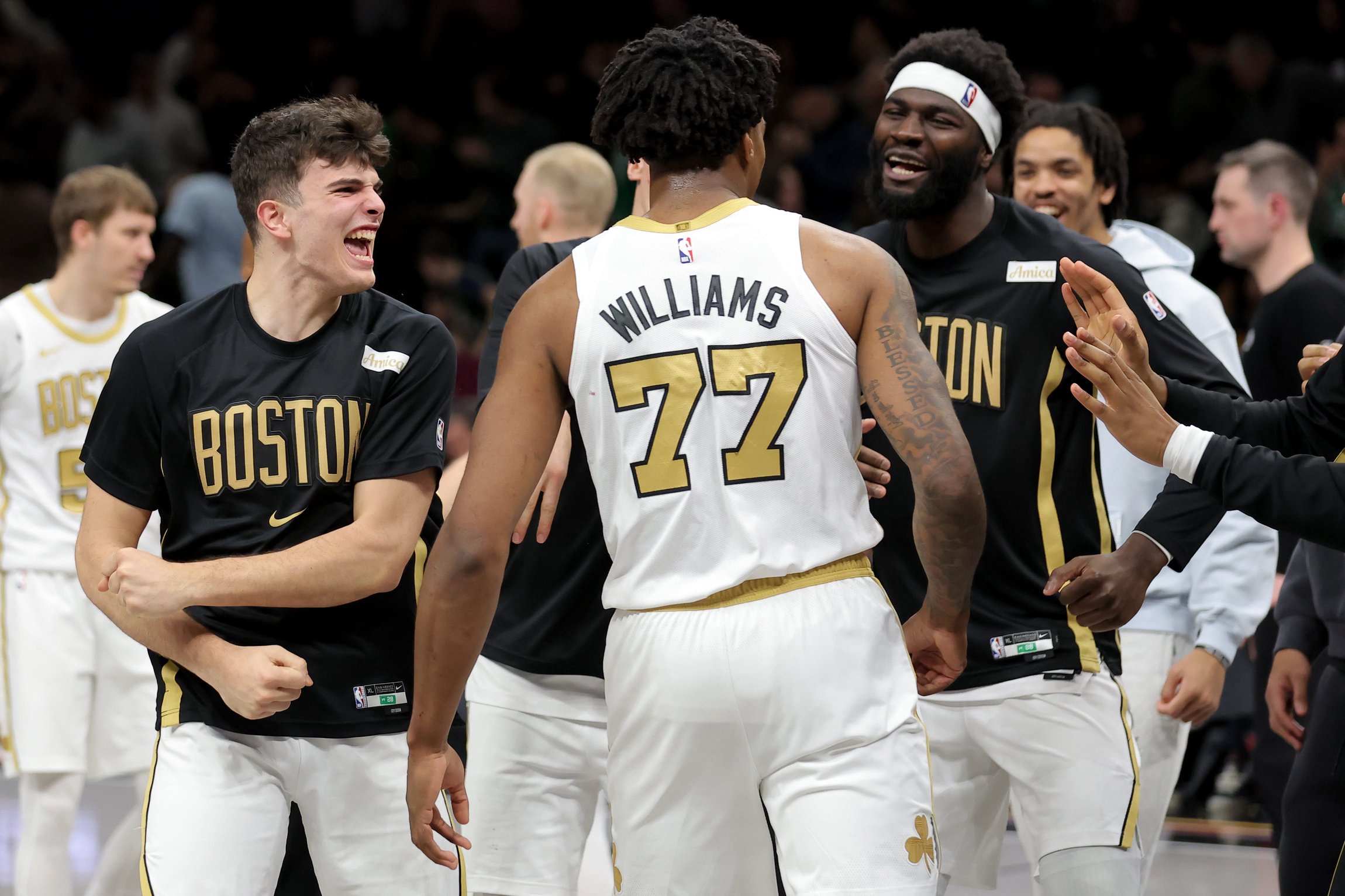 Jan 23, 2026; Brooklyn, New York, USA; Boston Celtics guard Hugo Gonzalez (28) and forward Amari Williams (77) and center Neemias Queta (88) celebrate after defeating the Brooklyn Nets in double overtime at Barclays Center. Mandatory Credit: Brad Penner-Imagn Images