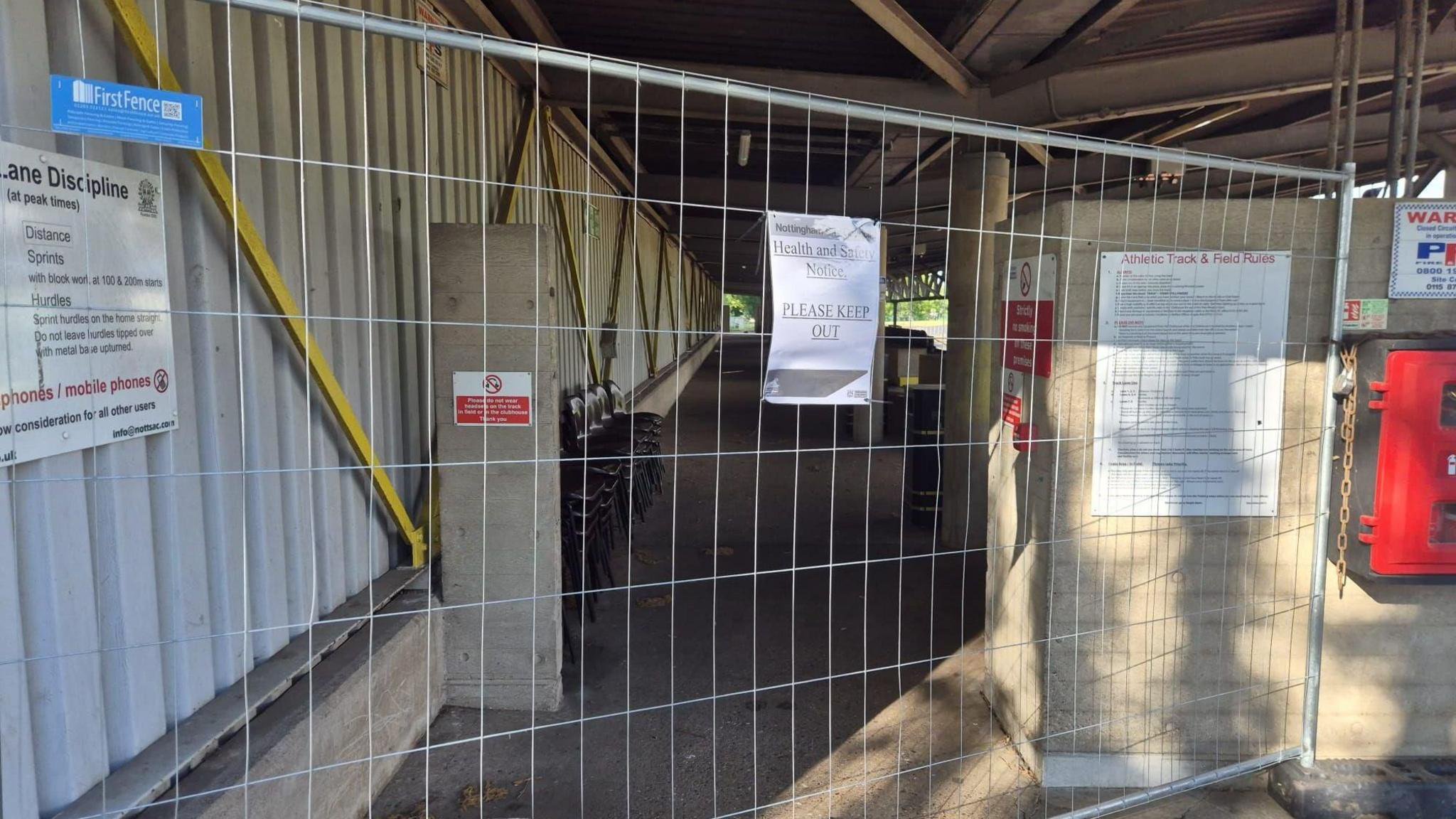 The main stand at the Harvey Hadden Stadium, with fencing preventing access.