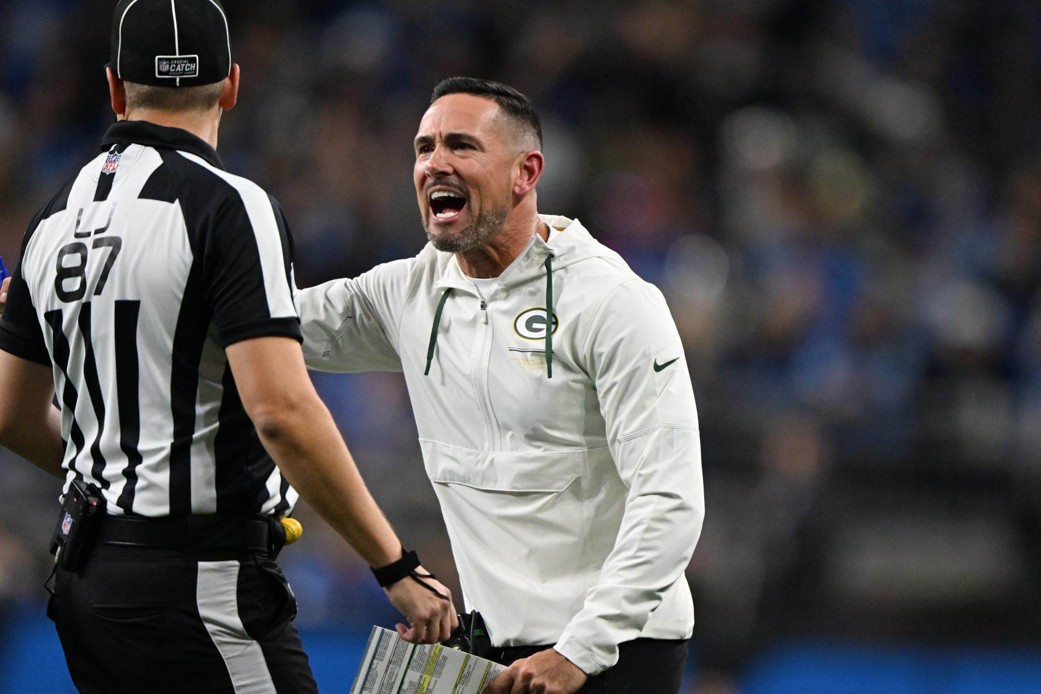 Green Bay Packers head coach Matt LaFleur reacts to an official during a game.