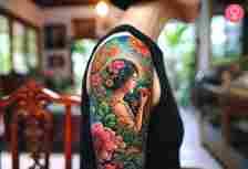Garden of Eden tattoo on the upper arm