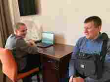 PHOTO: Blind journalist Volodymyr Pyrig teaches another veteran, Anton Bohach, to use a laptop in Lviv, Ukraine, in March 2024.  (ABC News)