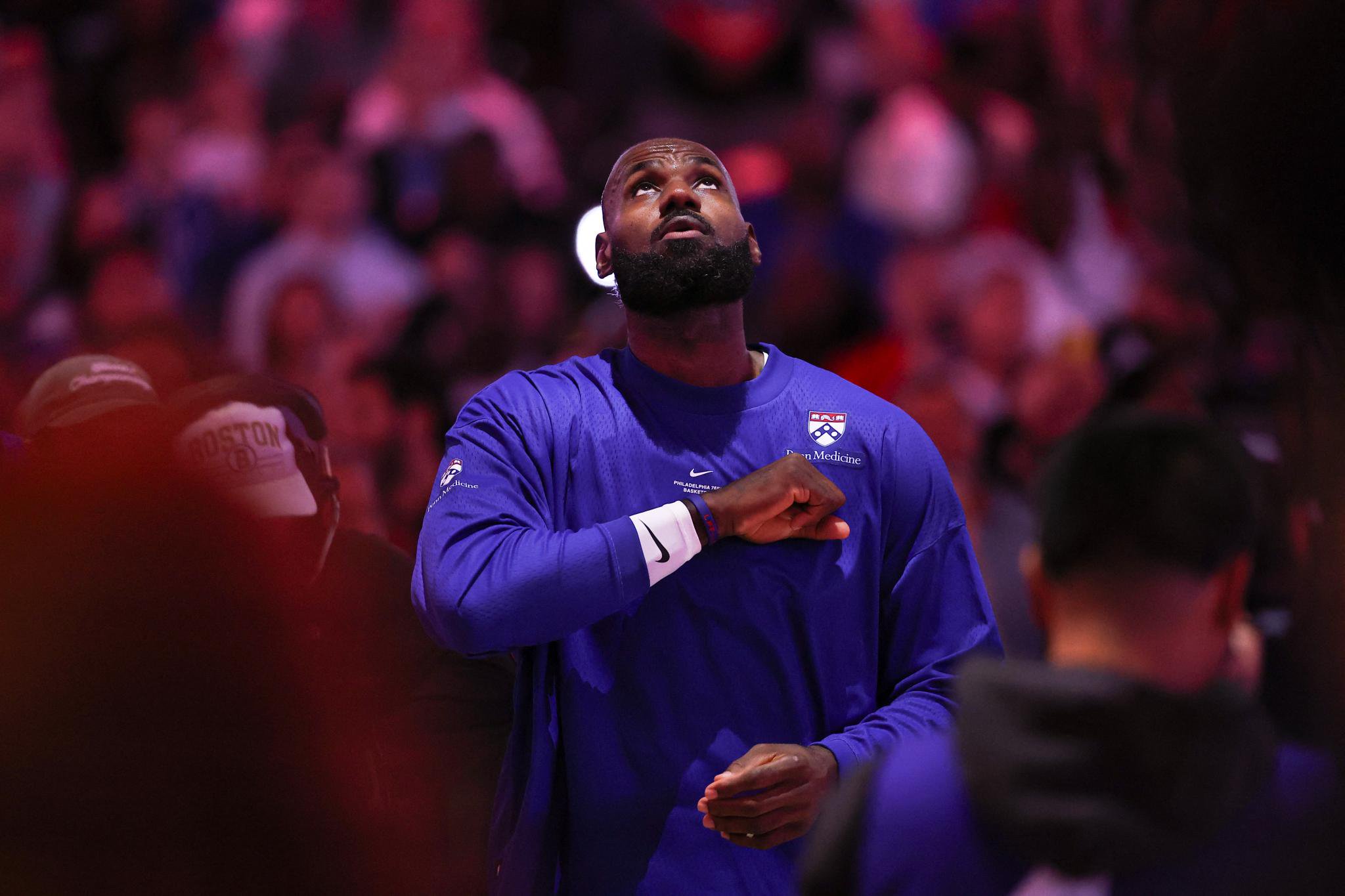 Philadelphia 76ers forward LeBron James stands with his hand on his chest during the anthem before a game against the Cleveland Cavaliers.