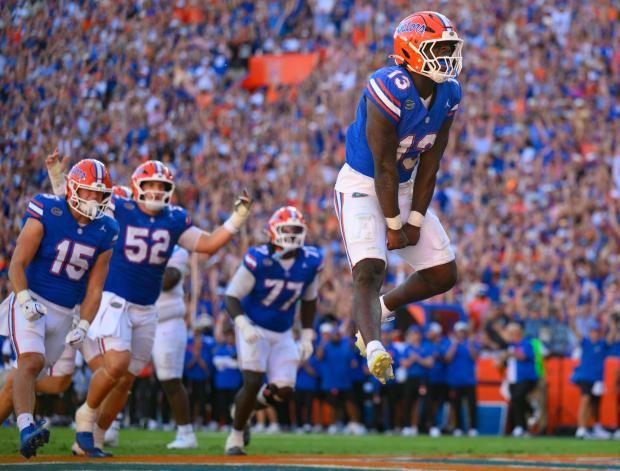 Florida running back Jadan Baugh (13) jumps in celebration after rushing for a touchdown during the Gators' 52-28 win against Ole Miss Sept. 26 in the Swamp. (AP Photo/Noah Lantor)