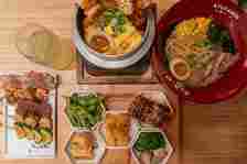 Kyuramen's kamameshi honeycomb platter, including yakatori, seaweed salad and chicken ramen