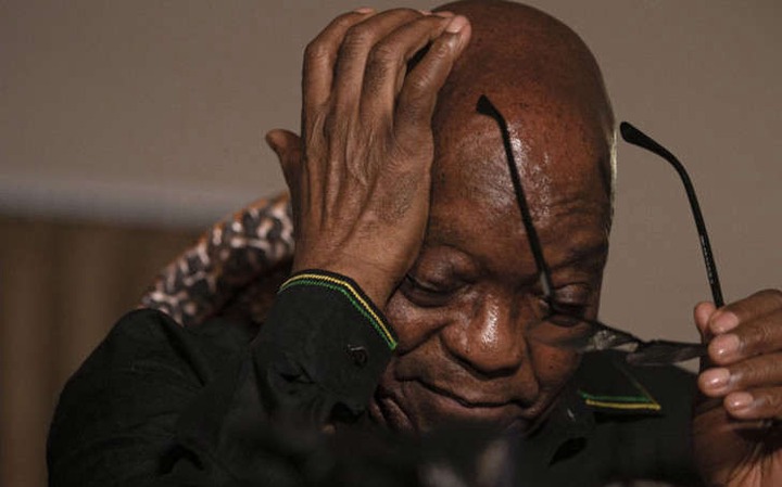 a man holding his head in his hands: FILE: Former South African President <a class=