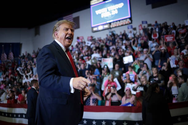 Republican presidential candidate and former President Donald Trump gestures to members of the audience as he leaves a Get Out The Vote rally at...