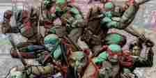 The Teenage Mutant Ninja Turtles with Splinter and Casey Jones in battle-ready positions.
