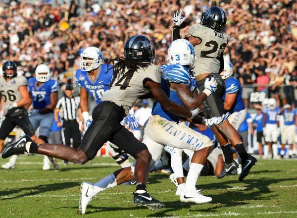 Dec 2, 2017; Orlando, FL, USA; UCF Knights defensive back Tre Neal (23) intercepts a pass in double overtime to end the game against the Memphis Tigers at Spectrum Stadium. Mandatory Credit: Matt Stamey-USA TODAY Sports