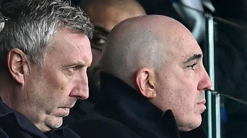 Manchester United's Director of Football, Jason Wilcox (L) and Manchester United's CEO, Omar Berrada (R) look on 