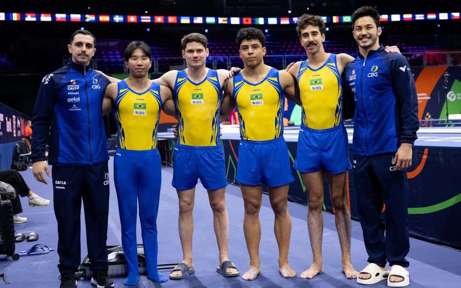 Seis ginastas da equipe de ginástica do Brasil, com uniformes amarelos e azuis, lado a lado.