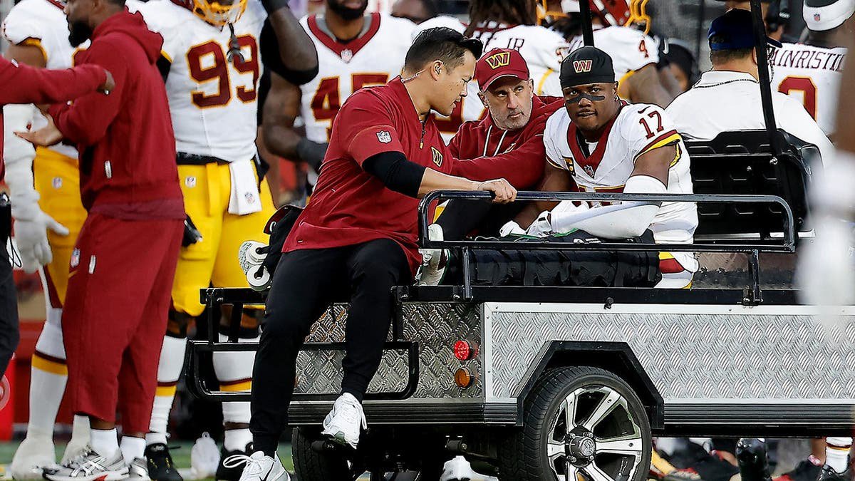 Terry McLaurin lies on a cart during an NFL game in Santa Clara, Calif.