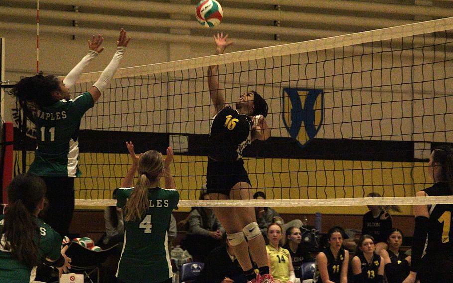 Vicenza girls’ volleyball team freshman opposite hitter Miosotis Castro jumps to spike the ball as Naples outside hitter Tinui Talio leaps to block it during a semifinal game of the 2026 DODEA-Europe volleyball championships Division II tournament at the Ederle Fitness Center gym on Caserma Ederle in Vicenza, Italy, on Friday, Oct. 30, 2026. 