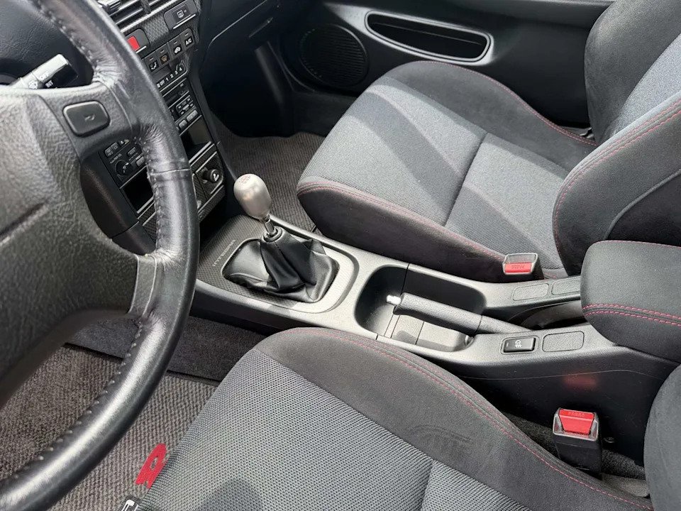 Black cloth and microsuede front seats with red stitching in a 2000 Acura Integra Type R