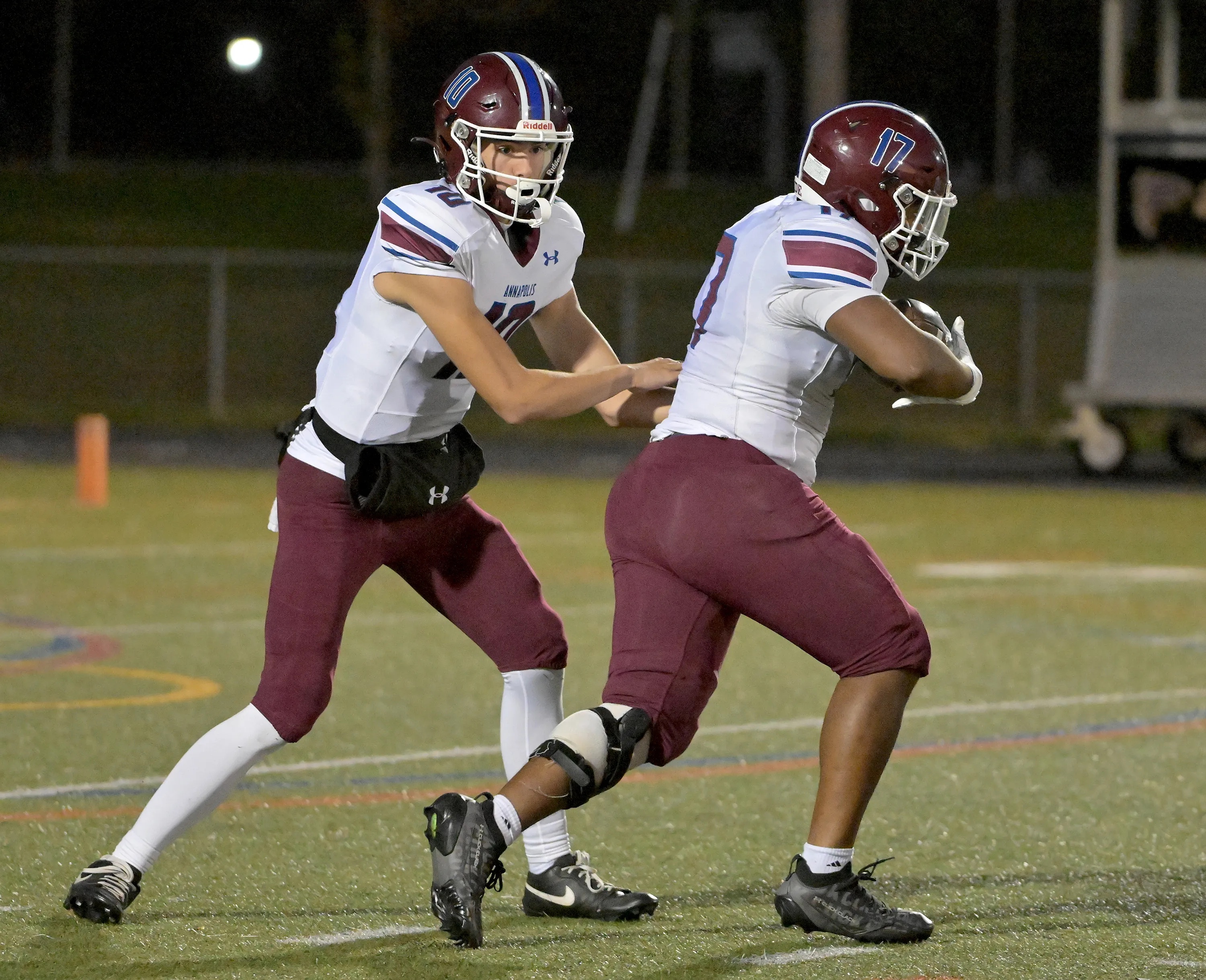 Annapolis Panthers quarterback Ayden Featherstone #10 hands off to Zhymarian Allen #17 in the second quarter. The Annapolis Panthers host the visiting Old Mill Patriots in a high school football held at Severna Park High School Friday evening. (Paul W. Gillespie/Staff)