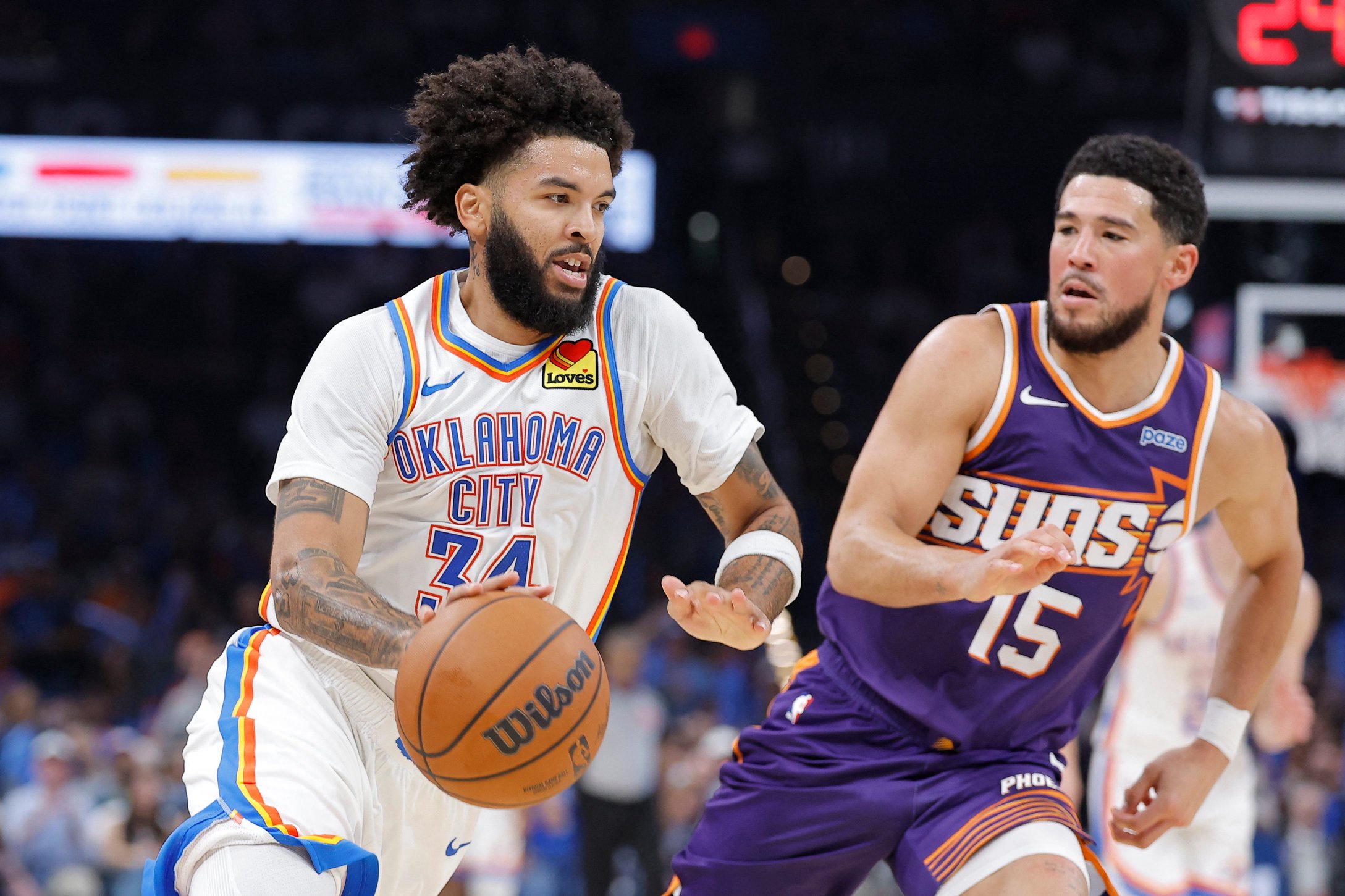 Oct 26, 2026; Oklahoma City, Oklahoma, USA; Oklahoma City Thunder guard Kenrich Williams (34) drives past Phoenix Suns guard Devin Booker (15) during the second half at Paycom Center. Mandatory Credit: Alonzo Adams-Imagn Images