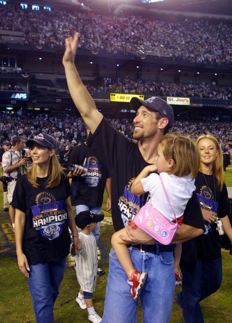 Arizona Diamondbacks' Luis Gonzalez waves to the crowd with his family during a victory celebration in November 2001.