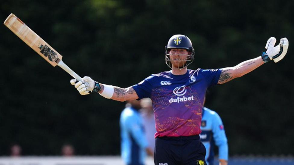 Ben Stokes holds his bat out in celebration as he hits a century against Derbyshire