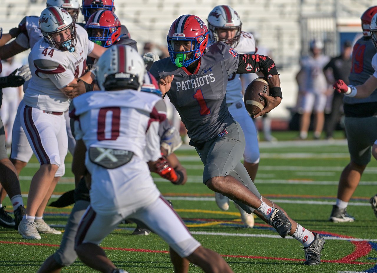 Old Mill Patriots quarterback Braylon Tucker #1 has a nice run for a touchdown in the first quarter. The Old Mill Patriots host the visiting Broadneck Bruins in high school football at the Severn Run High School. (Paul W. Gillespie/Staff)
