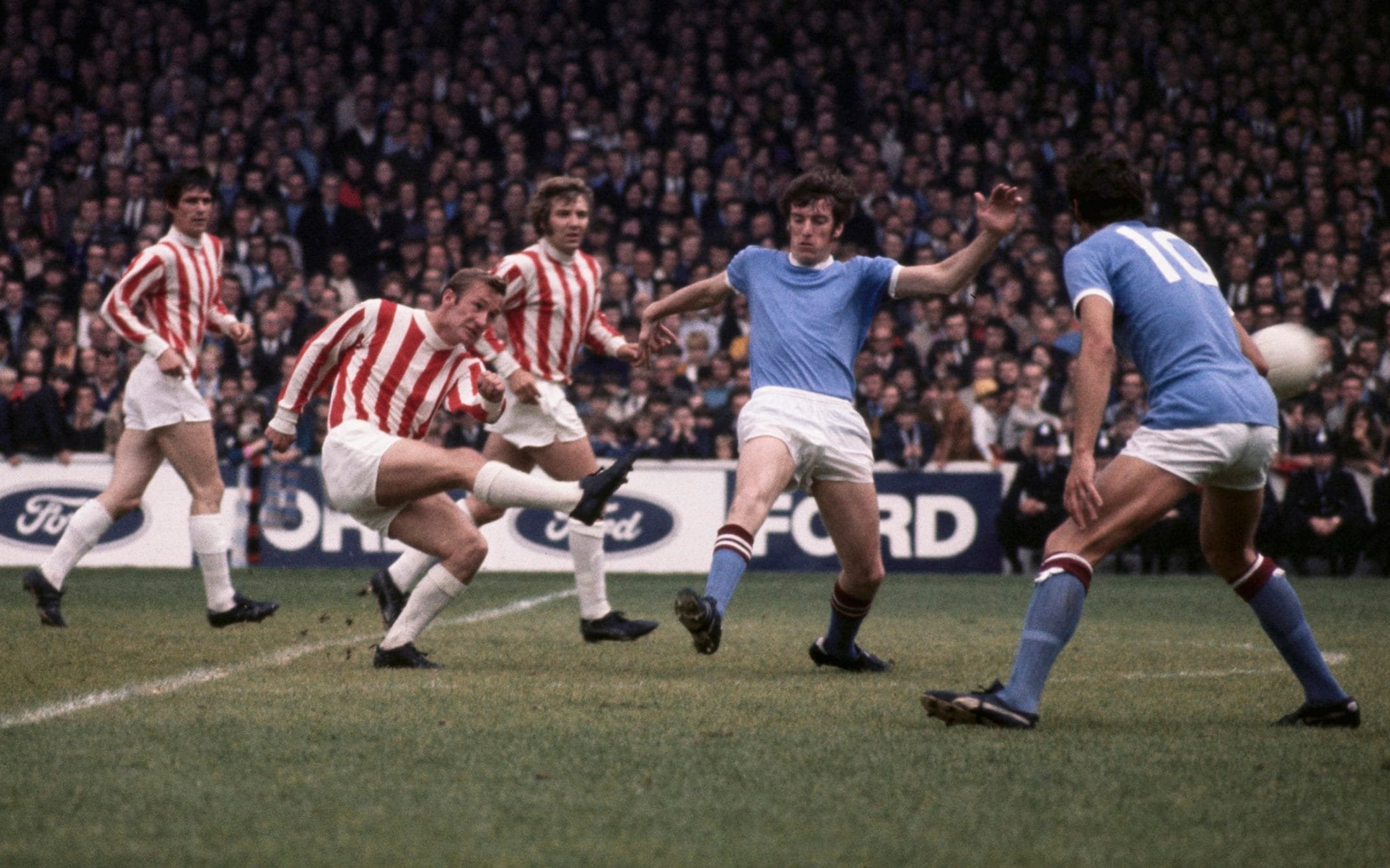 Peter Dobing takes a shot on goal for Stoke against his former club, Manchester City, at Maine Road in 1970, with, l-r, John Ritchie, Mike Pejic, Tommy Booth and Neil Young