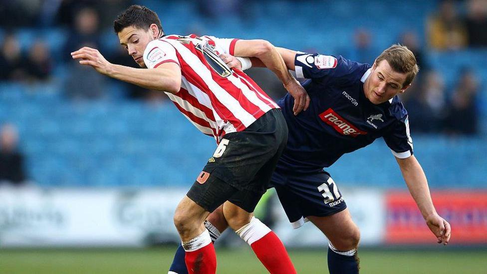 Harry Kane of Millwall tangles with Aaron Martin of Southampton during the FA Cup Fourth Round match between Millwall and Southampton at The Den on January 28, 2012 