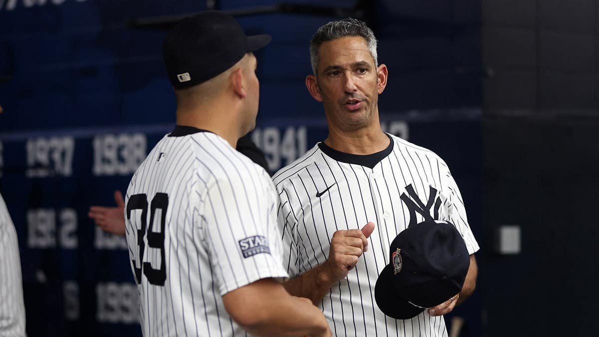 Jorge Posada and Jose Trevino talk at Yankee Stadium.