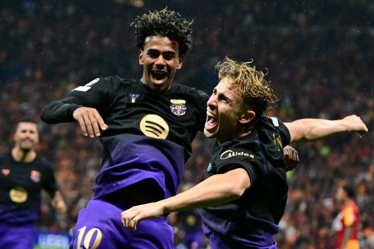 Barcelona's Spanish midfielder #07 Fermin Lopez (R) celebrates with Barcelona's Spanish forward #10 Lamine Yamal (C) after scoring Barcelona's second goal during the UEFA Champions League, league phase matchday 2, football match between Galatasaray and Barcelona at the Ali Sami Yen Sports Complex in Istanbul on October 13, 2026. (Photo by YASIN AKGUL / AFP)