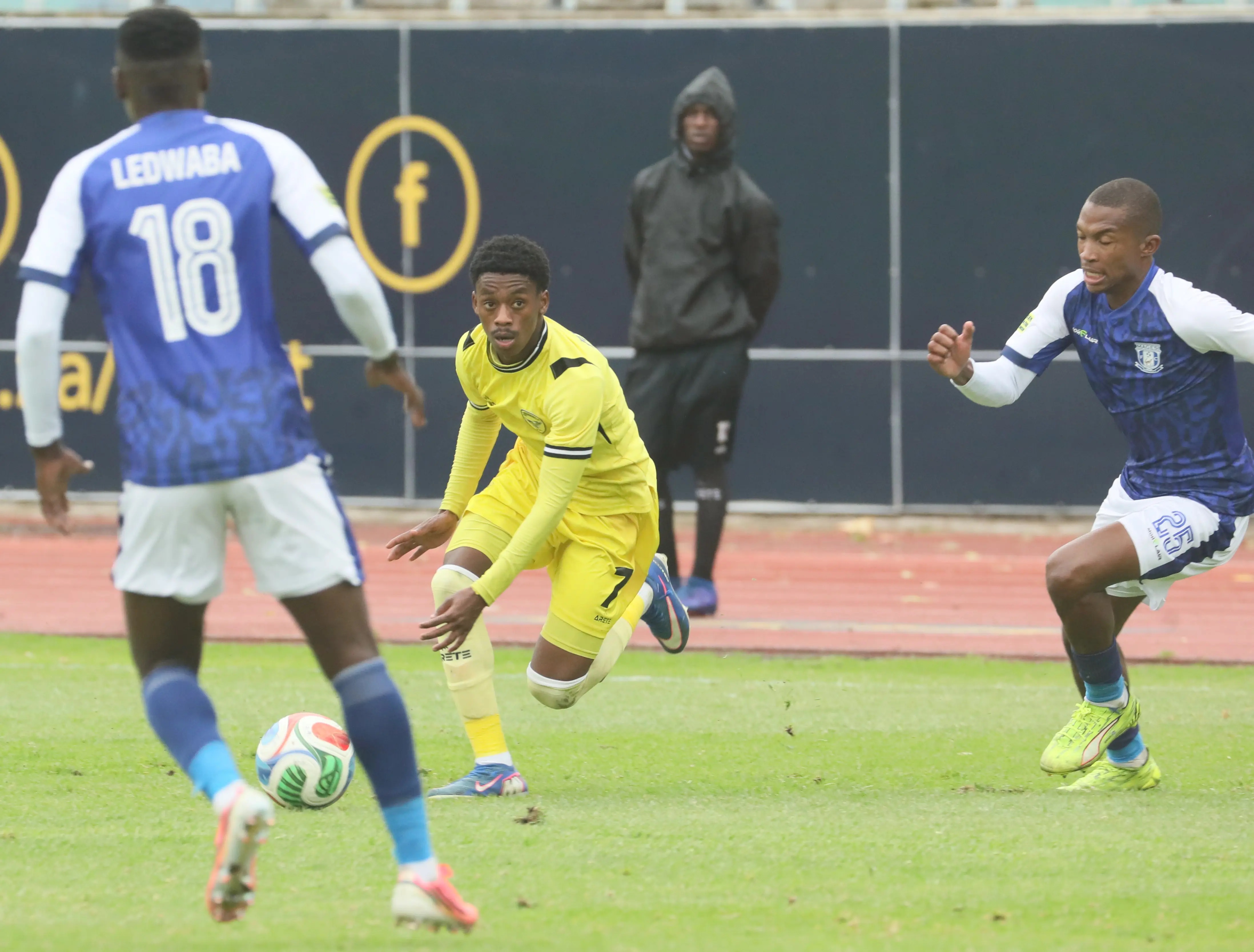 Highbury’s Unathi Funani runs at Magesi players Seun Ledwaba, left, and Thabang Ramolomo during a previous encounter at the Nelson Mandela University Stadium