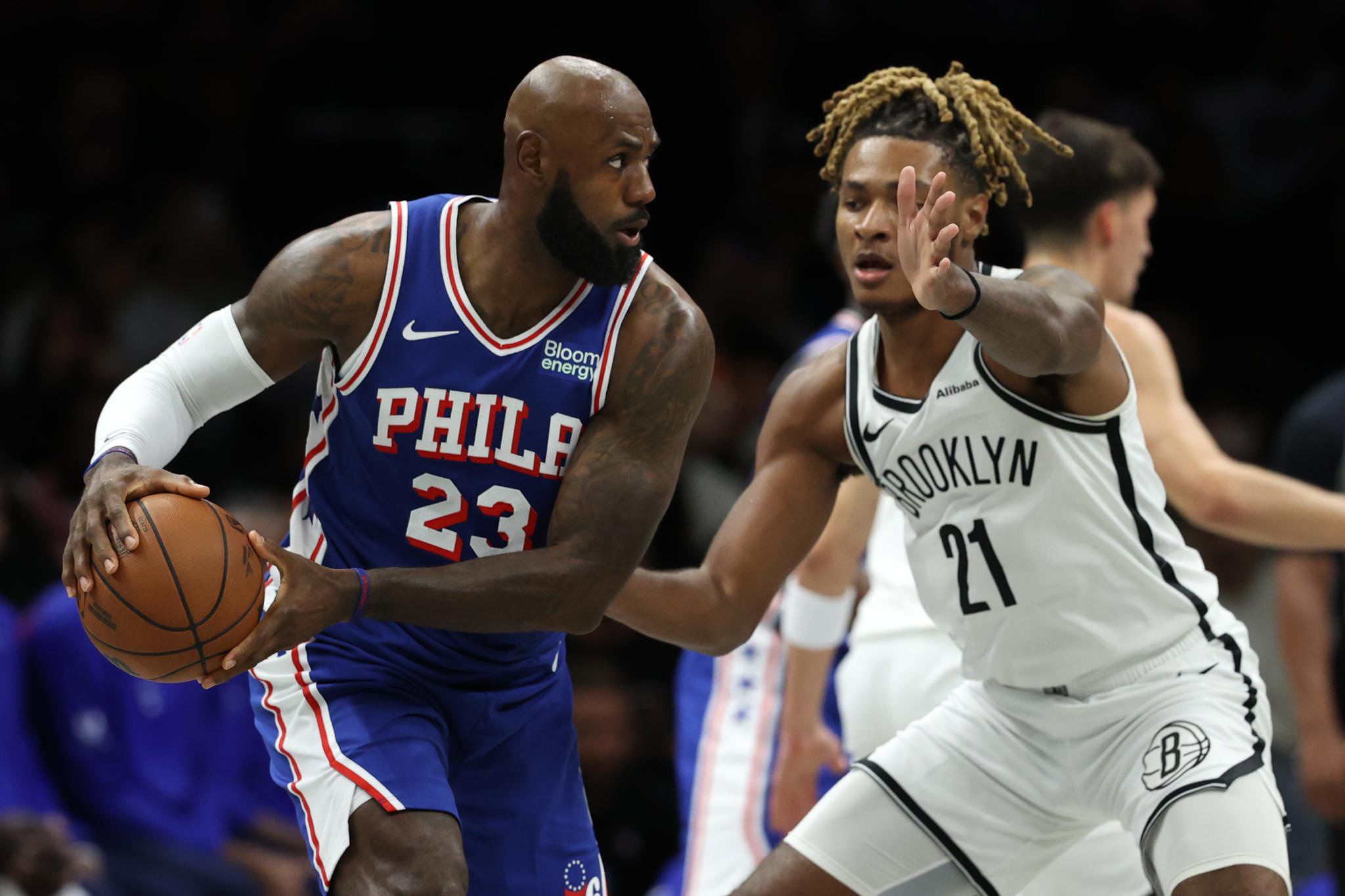 Philadelphia 76ers' LeBron James (23) looks to pass the ball against Brooklyn Nets' Noah Clowney (21) during the first half of a preseason NBA basketball game Thursday, Oct. 8, 2026, in New York.