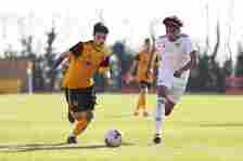 Lee Harkin of Wolverhampton Wanderers (L) runs with the ball under pressure from Keenan Carole of Leeds United during the U18 Premier League match ...