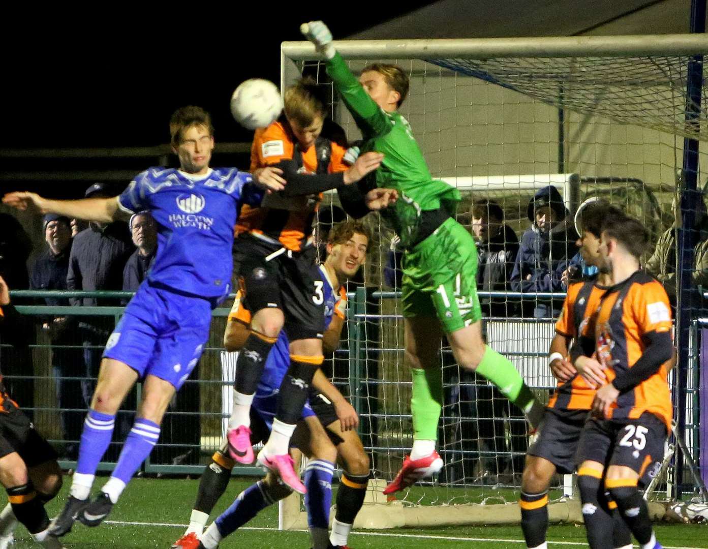 Folkestone forward Joe Pigott does his defensive duties while No.1 Ted Collins tries to punch clear under pressure from Tonbridge’s Ethan Sutcliffe on Tuesday. Picture: David Couldridge