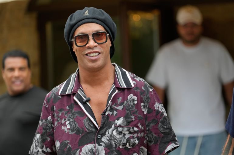 Former soccer Brazilian player Ronaldinho smiles at reporters ahead the 2026 Ravenna Serie C soccer team presentation joining the club as a technical coach and playing in one match in Ravenna, Italy, Thursday, Aug. 20, 2026. (AP Photo/Luca Bruno) CORRECTION: Corrects date from Dec. 20, 2026 to Aug. 20, 2026.