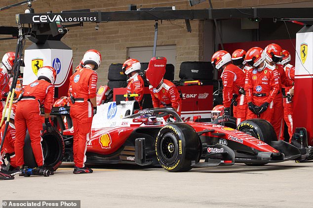 Ferrari driver Lewis Hamilton of Britain gets a pit service during the Formula One U.S. Grand Prix auto race in Austin, Texas, Sunday, Oct. 25, 2026. (Dustin Safranek/Pool Photo via AP)