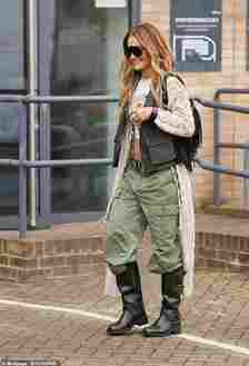 The You And Me hitmaker teamed the casual top with a pair of low-rise khaki cargo trousers and added inches to her frame with a pair of stylish black leather knee-high boots