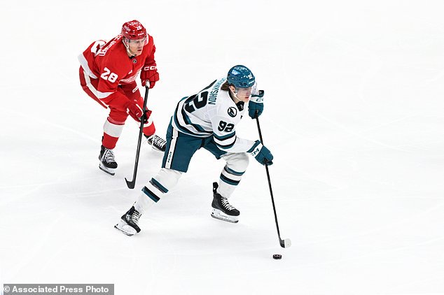 San Jose Sharks left wing Igor Chernyshov, right, prepares to pass in front Detroit Red Wings right wing Michael Brandsegg-Nygård during the first period of an NHL hockey game, Saturday, Oct. 17, 2026, in Detroit. (AP Photo/Jose Juarez)