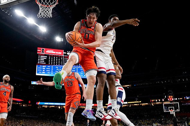 FILE - Illinois forward David Mirkovic (0) rebounds over UConn forward Tarris Reed Jr. during the first half of an NCAA college basketball tournament semifinal game at the Final Four, April 4, 2026, in Indianapolis. (AP Photo/Abbie Parr, File)