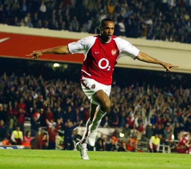 LONDON - APRIL 16: Thierry Henry of Arsenal celebrates scoring Arsenal's second goal during the FA Barclaycard Premiership match between Arsenal and Manchester United held on April 16, 2003 at Highbury in London, England. The match ended in a 2-2 draw. (Photo By Ben Radford/Getty Images)
