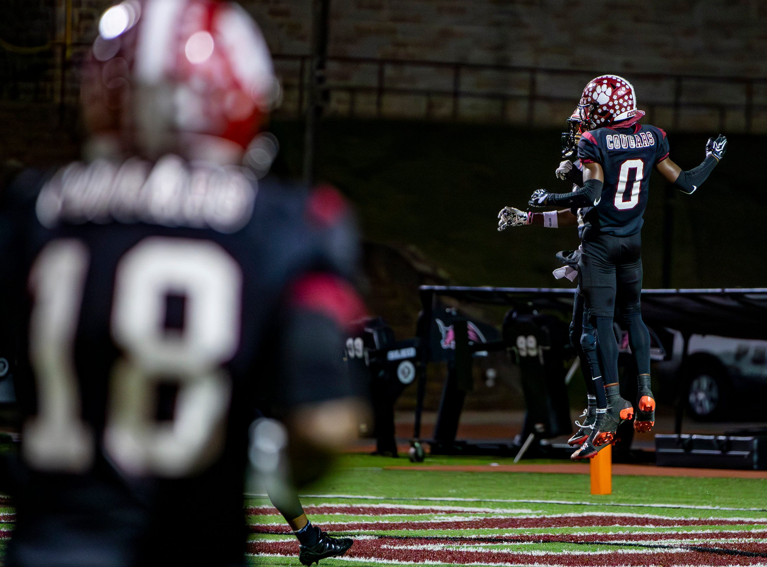 Asheville High receivers Kaydan Whiteside (1) and Jam Skyes (0) celebrate after a touchdown against Enka in Asheville, N.C., Oct. 30, 2026.