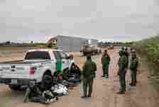 MISSION, TEXAS - DECEMBER 11: U.S. Border Patrol agents detain undocumented immigrants caught near a