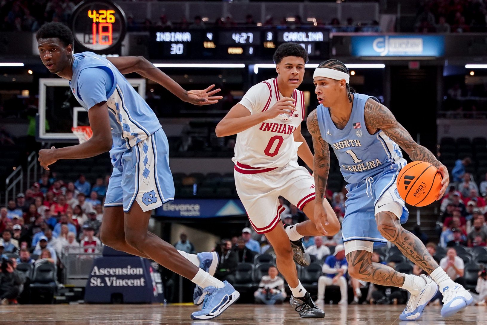 Oct 18, 2026; Indianapolis, IN, USA; North Carolina Tar Heels guard Terrence Brown (1) dribbles the ball against Indiana Hoosiers forward Trevor Manhertz (0) during the first half at Gainbridge Fieldhouse. Mandatory Credit: Robert Goddin-Imagn Images