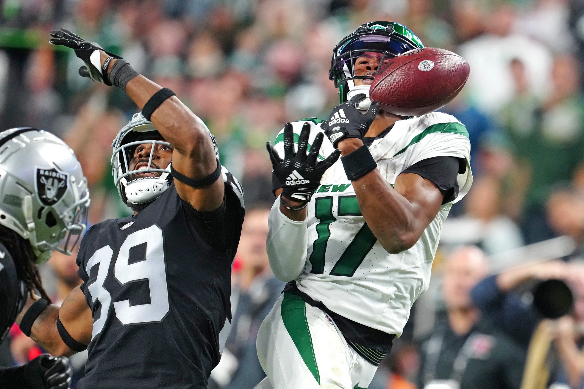 Nov 12, 2023; Paradise, Nevada, USA; New York Jets wide receiver Garrett Wilson (17) misses a reception as Las Vegas Raiders cornerback Nate Hobbs (39) defends on the play during the fourth quarter at Allegiant Stadium. Mandatory Credit: Stephen R. Sylvanie-USA TODAY Sports