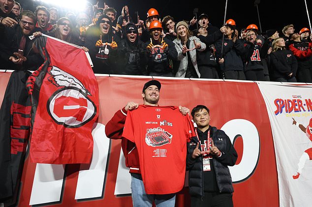 Buffalo Bills NFL tight end Dalton Kincaid, bottom left, a former Utah player, has a photo taken with the Utah student section prior to an NCAA college football game against Houston, nSaturday, Oct. 24, 2026, in Salt Lake City. (AP Photo/Jeffrey D. Allred)