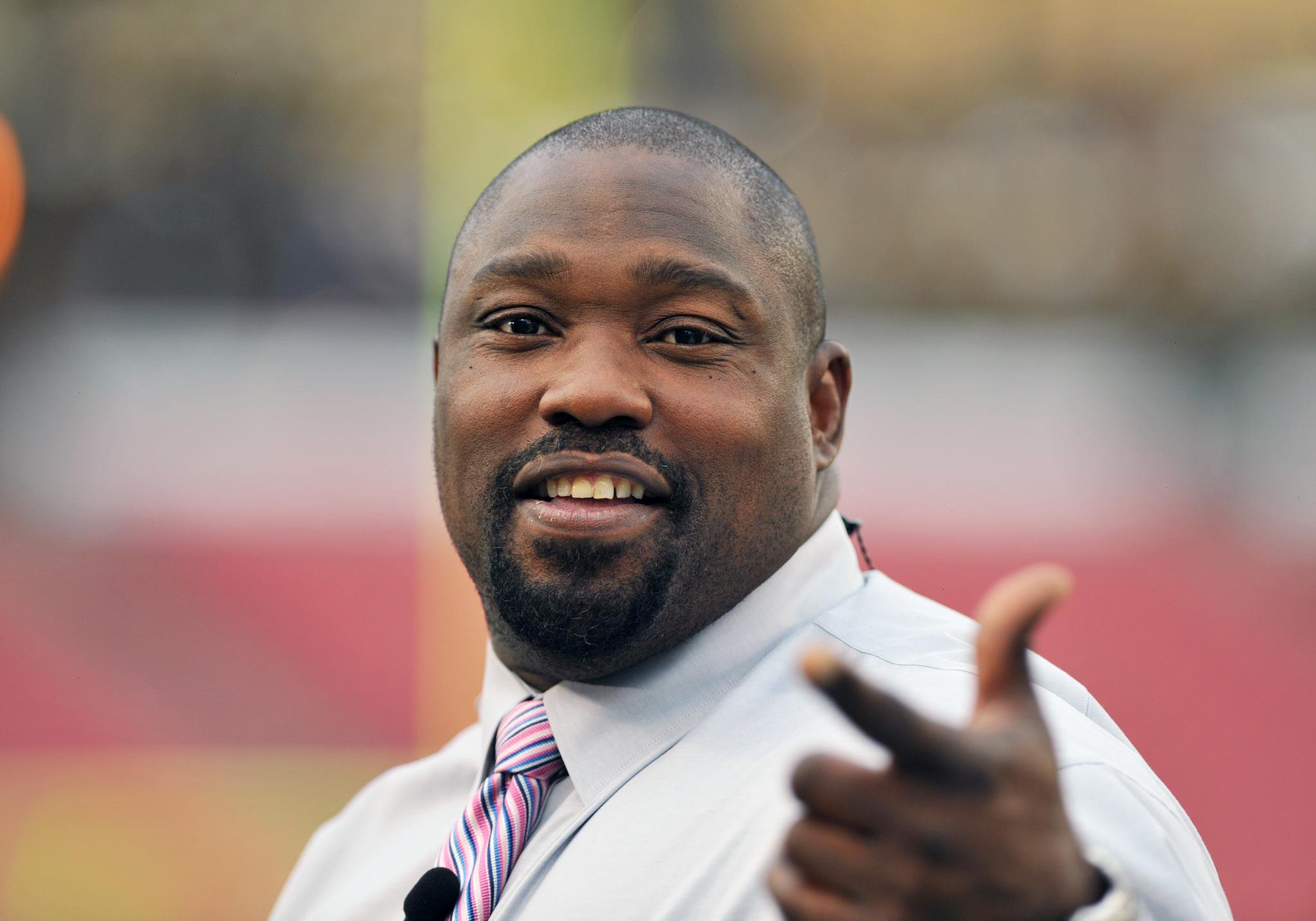 NFL television commentator Warren Sapp on the field.