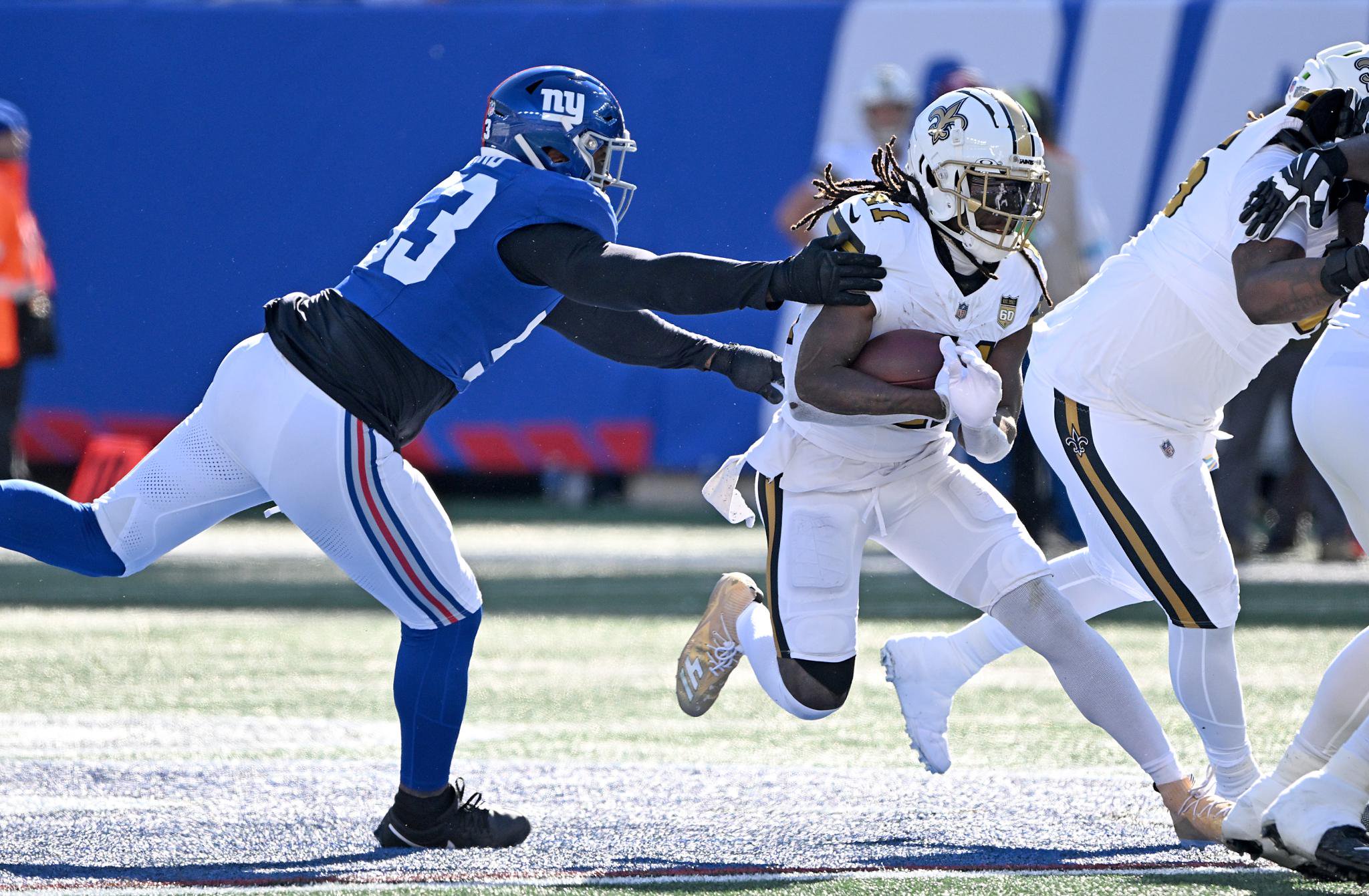 Saints running back Alvin Kamara (41) breaks away from Giants linebacker Jihad Ward (53) and runs the ball during the third quarter of an NFL football game in East Rutherford, N.J., Sunday, Oct. 18, 2026.