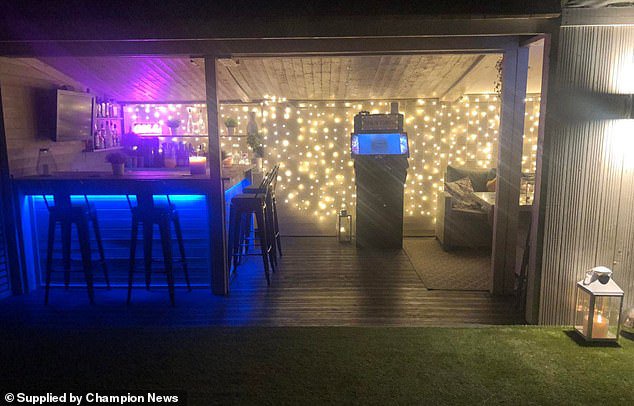 The so-called 'den' featuring a TV, bar, plastered walls, carpeting, furniture and an electric doorbell was first erected at the bottom of the Salmons' garden in 2018