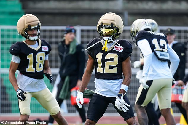 New Orleans Saints wide receiver Chris Olave (12), center, and New Orleans Saints wide receiver Bryce Lance (18), right, during an NFL football practice session in Versailles near Paris, Wednesday, Oct. 21, 2026. (AP Photo/Aurelien Morissard)