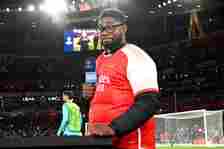 Micah Richards, former English football player and current TNT Sports pundit, wears an Arsenal shirt prior to the UEFA Champions League 2023/24 rou...