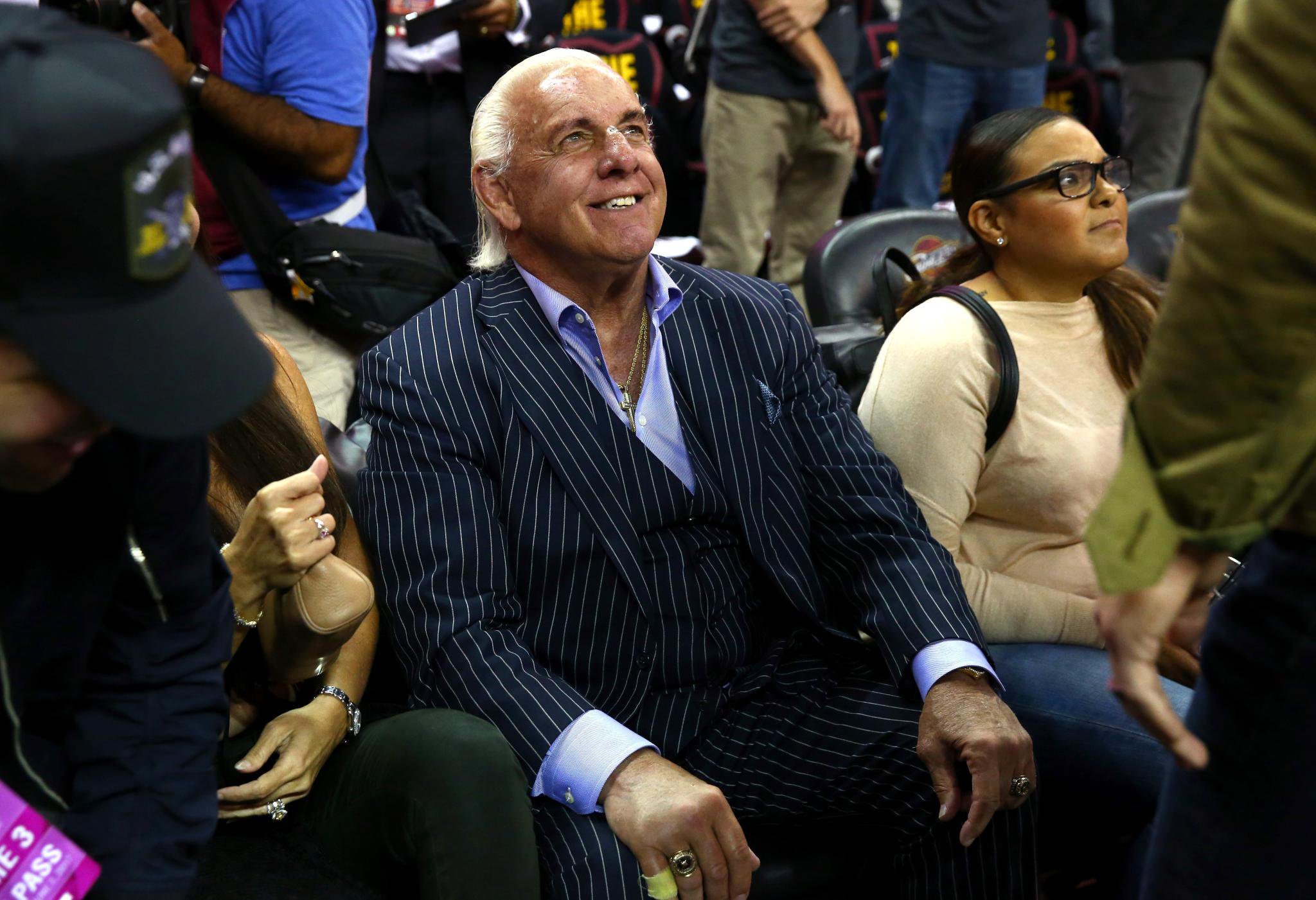 Former wrestler Ric Flair sitting courtside at the NBA Finals.