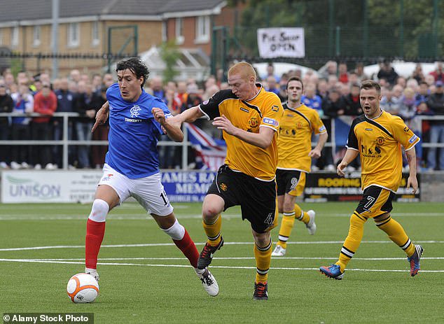 Steven Swinglehurst keeps a close eye on Rangers striker Fran Sandaza in 2013