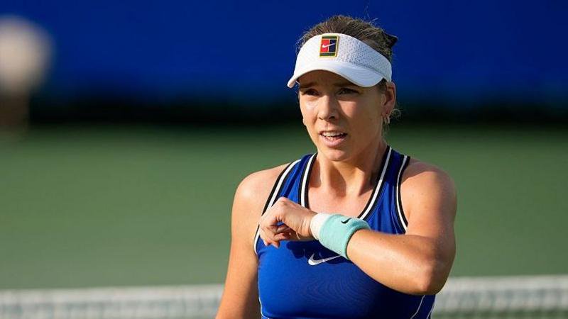 Katie Boulter, wearing a blue dress and white visor