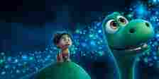 Arlo and Spot look at the fireflies in The Good Dinosaur